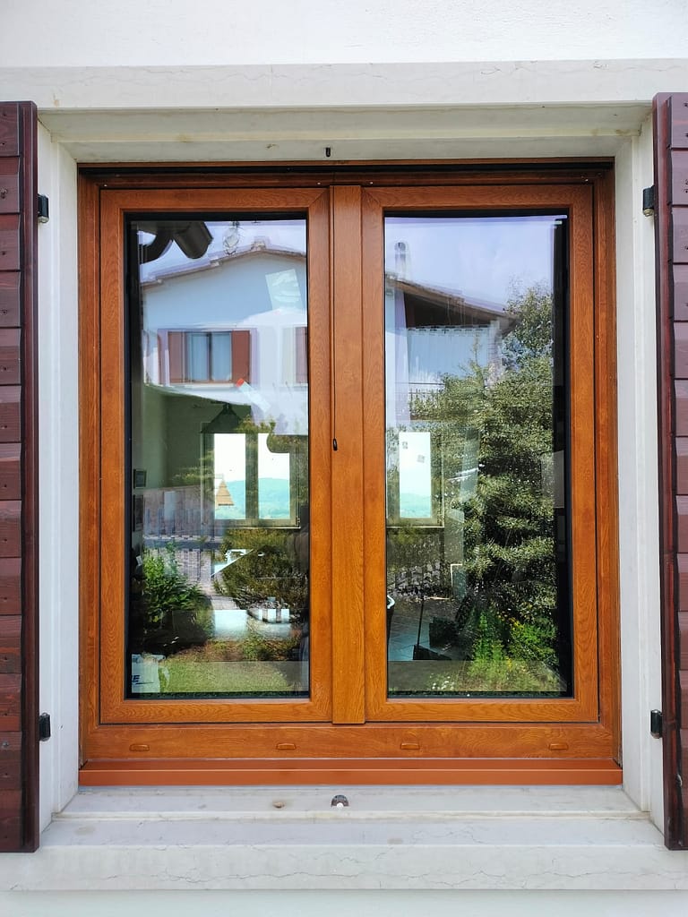 Finestra in pvc effetto legno con scuri colore mogano. Installati ad Arcole. Serramento OK